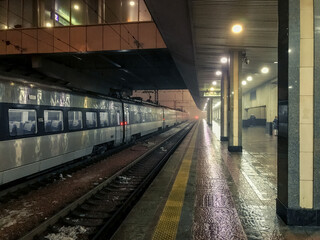 Kiev Central Railway Station. Empty platform and train on rails at night