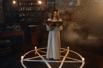 Fototapeta na wymiar Woman with book of spells standing in magic circle