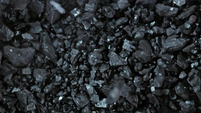 Super Slow Motion Shot of Crushing Coal on Black Background at 1000 fps.