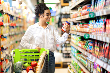 Happy Black Woman Doing Groceries Shopping Buying Products In Supermarket
