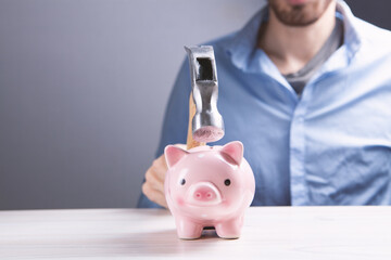 A sad pink piggy bank is about to be hit by a hammer in old vintage tone  Financial problem