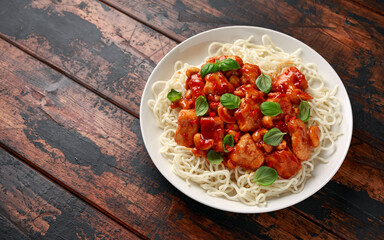 Sweet Chilli Chicken with noodles on wooden table. asian food