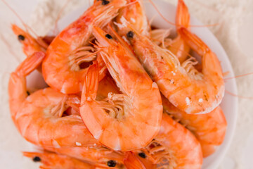 beautiful large boiled tiger prawns on a white plate on the kitchen table