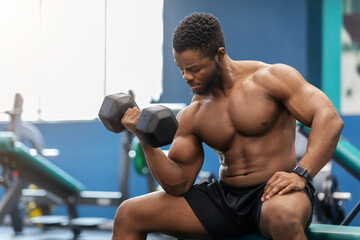 Naklejka na ściany i meble Handsome african american muscular man exercising with barbell