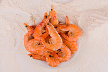 beautiful large boiled tiger prawns on a white plate on the kitchen table