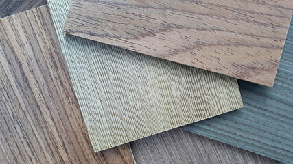 interior wooden veneer material samples (close up) containing many types of wood texture for example ash ,grey ash ,oak ,cherry ,douglas fir wood. interior laminated samples background.