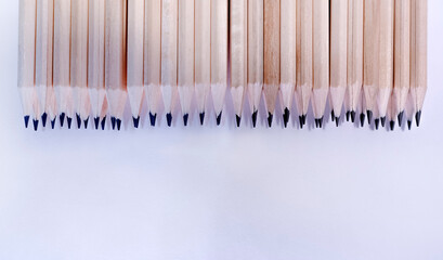 many simple pencils on a white sheet of paper