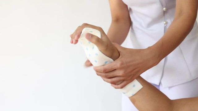A nurse splint and bandages are being applied to the injured hand.Cast and Splint Immobilization