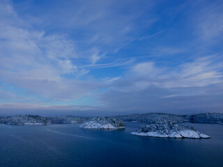 Cold morning at archipelago of Stockholm. Snow blanket over rocks.
