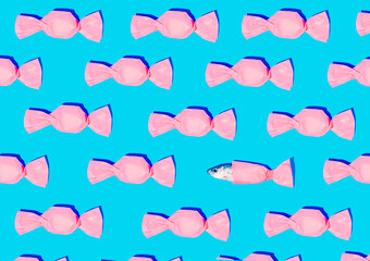 A creative idea of a fish that came out of isolation from a pink candy on a cyan background....