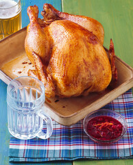 Roast chicken on the dining table in a roasting pan