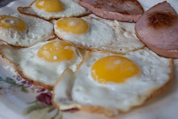 Fried eggs in a frying pan. Process of cooking eggs closeup. Food Background