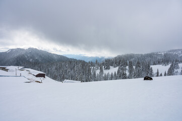 Snow covered mountain hut in Ciucas mountains during Romanian winter