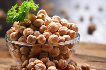 Composition with bowl of chickpeas on wooden table