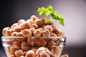 Composition with bowl of chickpeas on wooden table