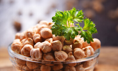 Composition with bowl of chickpeas on wooden table
