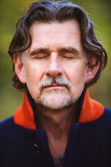 Obraz premium handsome bearded man in his 50s with eyes closed