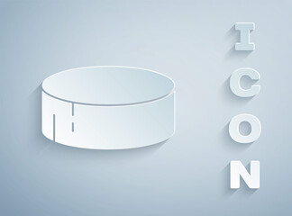 Paper cut Hockey puck icon isolated on grey background. Sport equipment. Paper art style. Vector Illustration.