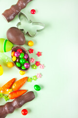 Easter set with eggs, carrots, chocolate bunny, cookie cutter. Top view. Copy space.