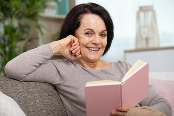 happy senior woman wearing relaxing with a book