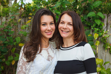 Mother and daughter portrait in a outdoor home setting