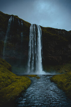Waterfalls on green grass field