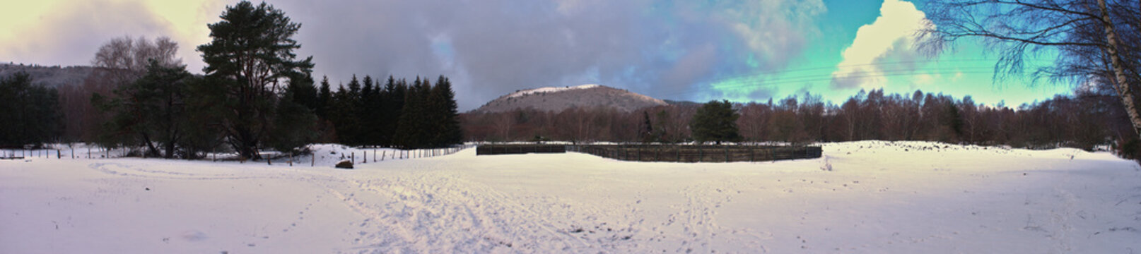 panoramic view of the Puy-de-Dome and the snow-capped meadow, at Col des Goules in Orcines, Puy de Dome department, Auvergne region in France