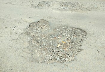 A potholed asphalt road.