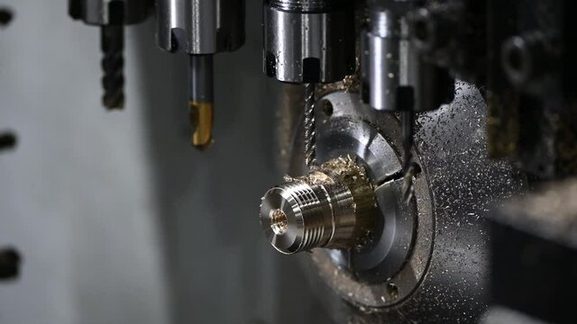 The  operation of multi-tasking CNC lathe machine cutting the fitting part. The hi-technology pipe connector parts by CNC turning machine.