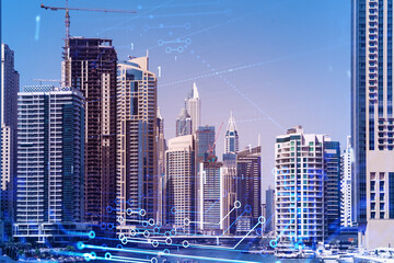 Skyscrapers of Dubai business downtown. International hub of trading and financial services. Technology theme icons hologram, concept of big data. Double exposure. Dubai Canal waterfront.