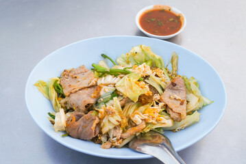 Dried suki in a bowl with dipping sauce on the street food table in Thailand. 