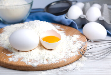 Ingredients for making baking dough: flour, eggs on a table. Close-up.