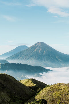 Green and white mountain under white clouds