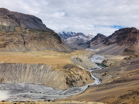 Brown and gray mountains under white clouds