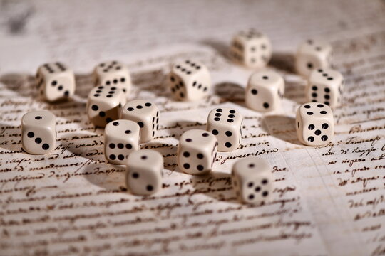 a bunch of dice on handwritten pages. Concept of destiny already written: predestination 