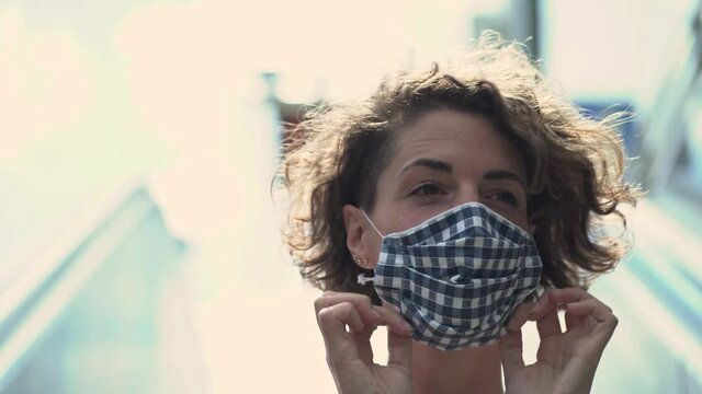 Beautiful Woman Putting On Face Mask While Entering The Subway Station By Escalator In Closeup Portrait