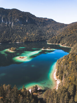 Lake Surrounded By Green Trees And Mountain