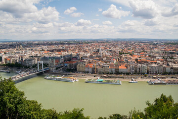 Fototapeta na wymiar View from Gellert Hill to Budapest. Beautiful architecture of the old and new city. Long bridge over the river Danube. A sunny day in Hungary.