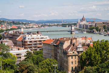 View from Gellert Hill to Budapest. Beautiful architecture of the old and new city. Long bridge over the river Danube. A sunny day in Hungary.