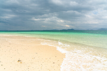 Fototapeta na wymiar White sand beach in khang khao island, Ranong, Thailand in cloudy day.