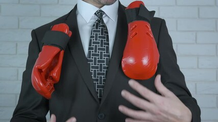 In a business suit with boxing gloves. Business man with boxing gloves. Business man with boxing gloves. - Powered by Adobe