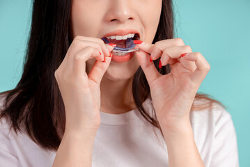 Dental Beautiful smiling of young asian woman with retainer braces glad emotion with white teeth increase confidence for healthy on blue background isolated, Happiness teenager facial expression.