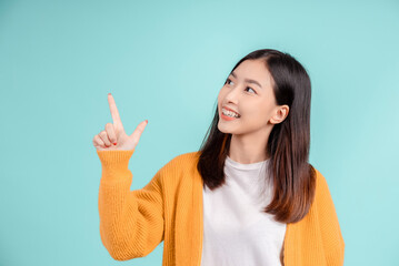 Dental of young asian woman wearing retainer braces glad emotion with white teeth increase confidence for healthy on blue background isolated, Happiness teenager smiling facial expression.