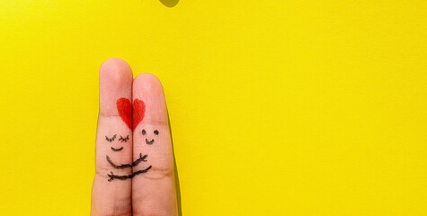 Valentines Day background. A happy couple with Red heart art on finger on an isolated colorful Background With Space.