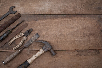 Collection of old woodworking handtools on a rough workbench wooden with copy space