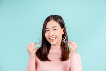 Dental Beautiful smiling of young asian woman with retainer braces glad emotion with white teeth increase confidence for healthy on blue background isolated, Happiness teenager facial expression.