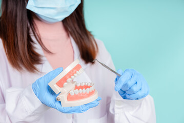 Asian dentists are teaching them how to care for oral and dental care, including after correct orthodontic treatment on blue background isolated studio shot.