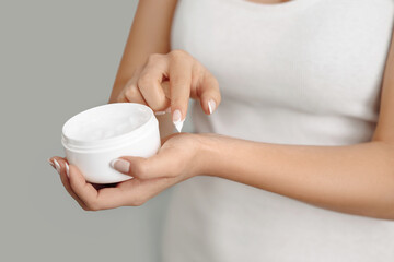 Closeup woman applying protective cream on hands. Hand skin care. Cosmetic cream. Beauty and body care concept