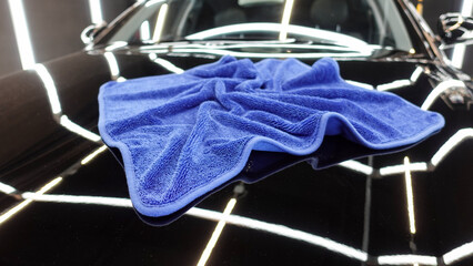 Blue cloth for wiping the car on the hood