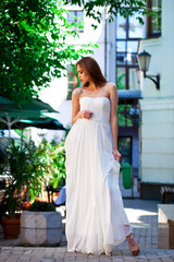 Fototapeta premium Portrait of beautiful model woman in wearing white dress